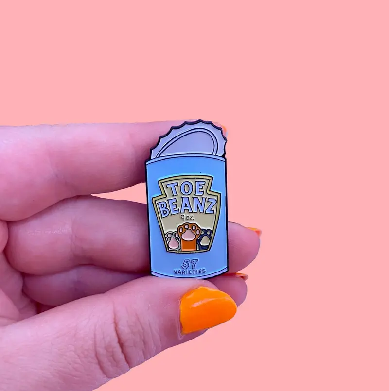 Toe Beanz Enamel Pin – Playful Footwear Character